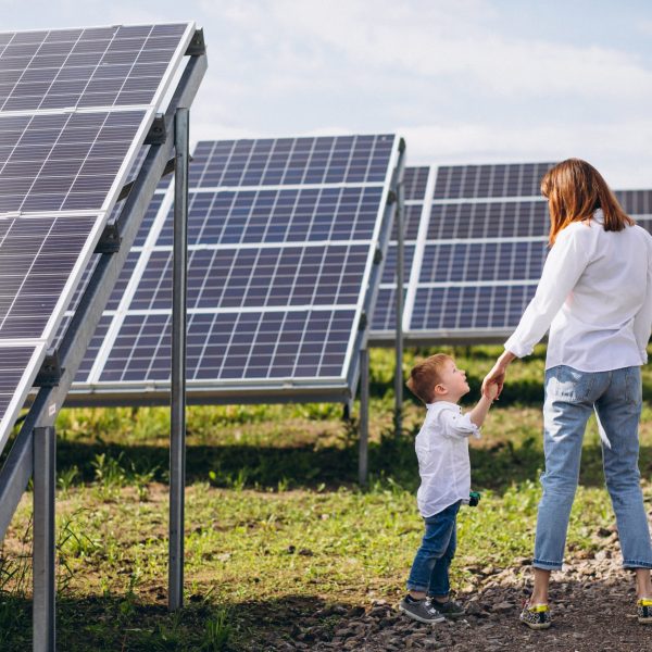 Mother with her little son by solar panels