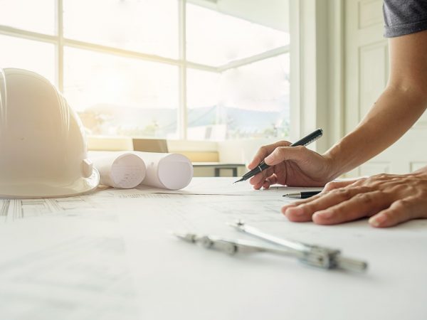 Hands of Engineer working on blueprint,Construction concept. Engineering tools.Vintage tone retro filter effect,soft focus(selective focus)